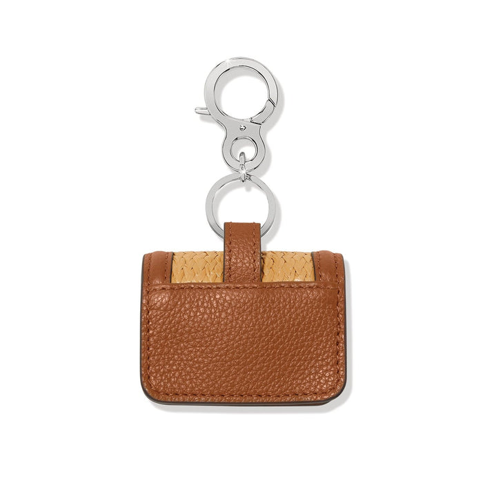 Brighton bag charm shown from the back in brown leather and faux straw with silver-tone clasp on a white background