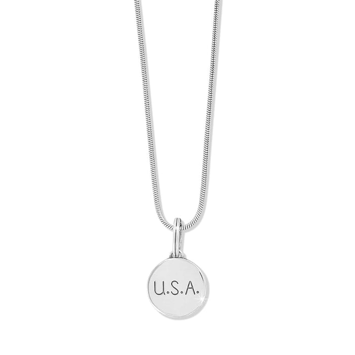 Brighton pendant necklace with silver-plated round U.S.A. engraved charm and snake chain on a white background