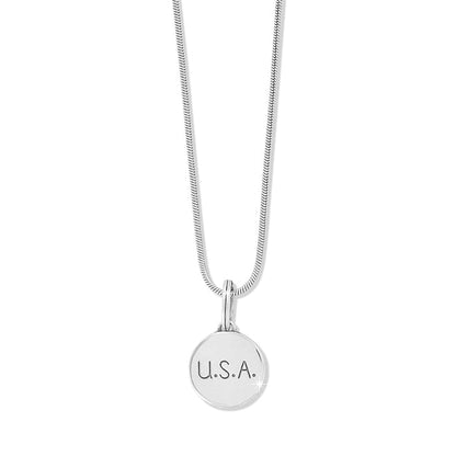 Brighton pendant necklace with silver-plated round U.S.A. engraved charm and snake chain on a white background