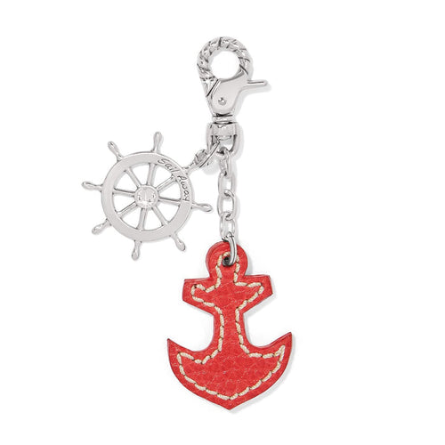 Brighton handbag charm with silver-plated ship wheel, crystal accent, and red leather anchor pendant on a white background