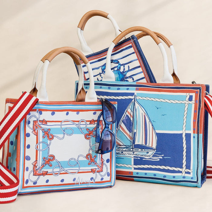 Brighton nautical totes styled with sunglasses, featuring sailboat, anchor, and crab prints in blue, red, and white