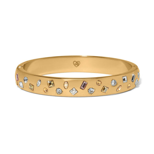 Brighton gold-plated bangle bracelet with scattered multicolored crystals in various shapes and sizes on a white background