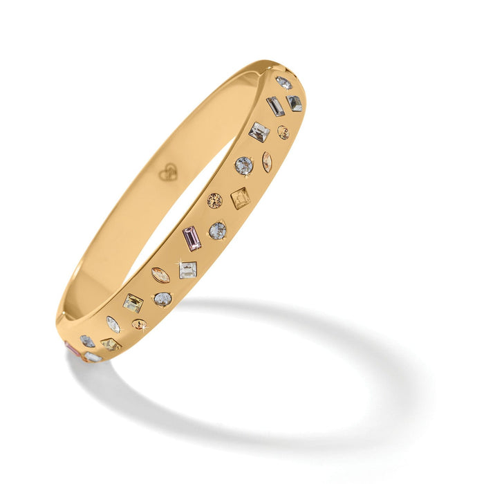 Brighton gold-plated bangle bracelet with scattered multi-shaped crystals in clear, pink, and amber tones on a white background