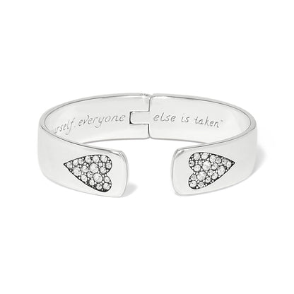 Brighton hinged cuff bracelet with silver-plated finish, crystal heart accents, and engraved interior message on a white background