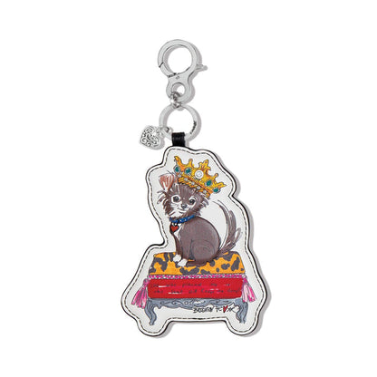 Brighton leather bag charm with illustrated crowned cat on cushion print and silver-tone clip on a white background