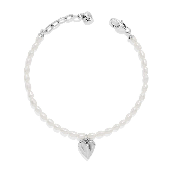 Brighton bracelet with rice pearls, silver-tone heart charm, and lobster clasp on a white background