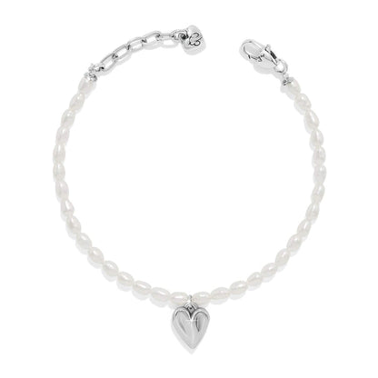 Brighton bracelet with rice pearls, silver-tone heart charm, and lobster clasp on a white background