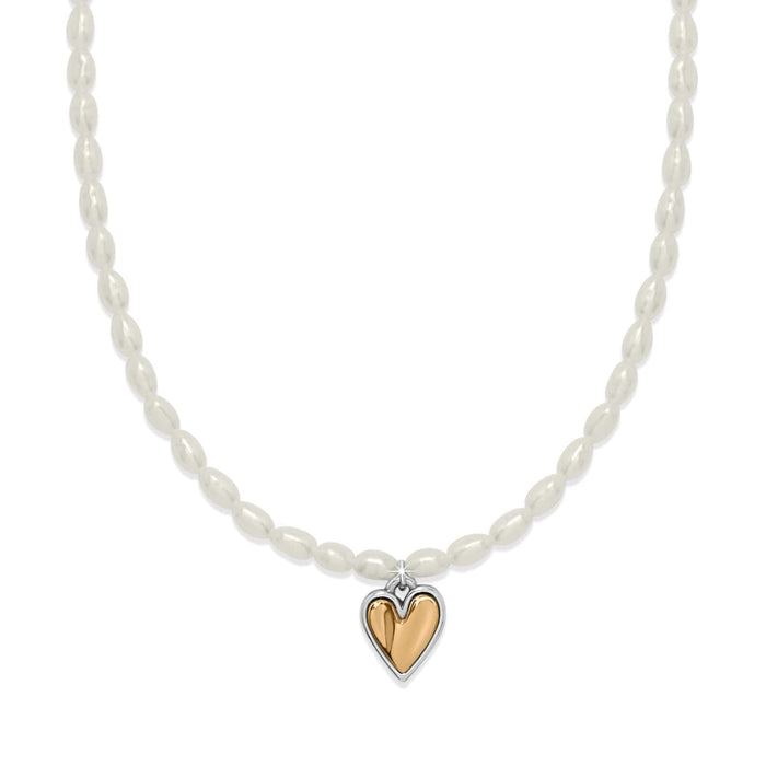 Brighton pearl necklace with rice pearls and two-tone heart pendant in silver and gold on a white background