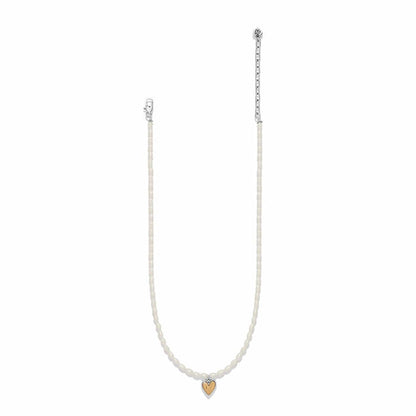 Brighton necklace with rice pearls, two-tone silver chain, and small gold heart pendant on a white background