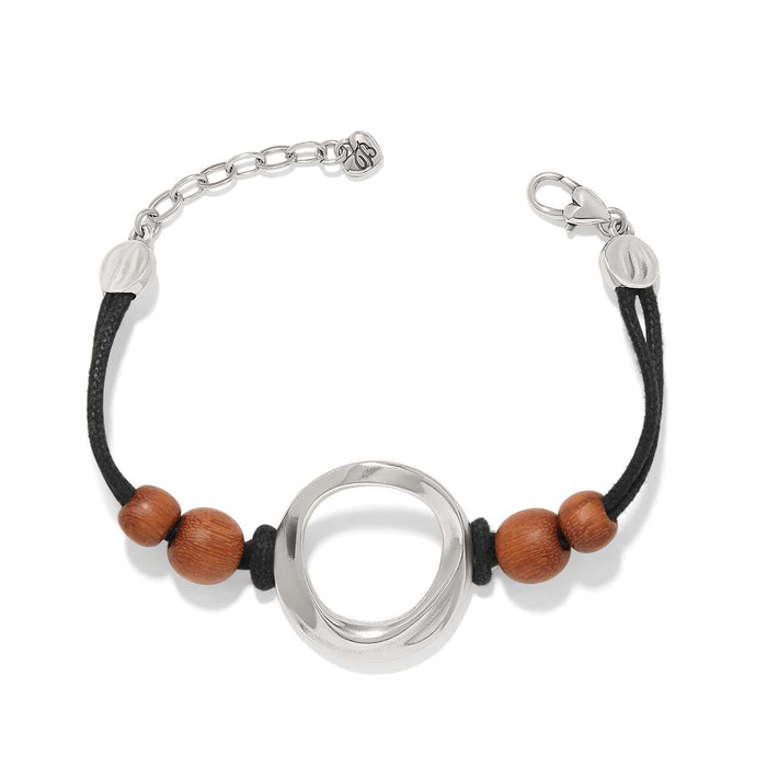 Brighton bracelet with silver-plated open circle centerpiece, wood beads, and black cord with adjustable chain on a white background