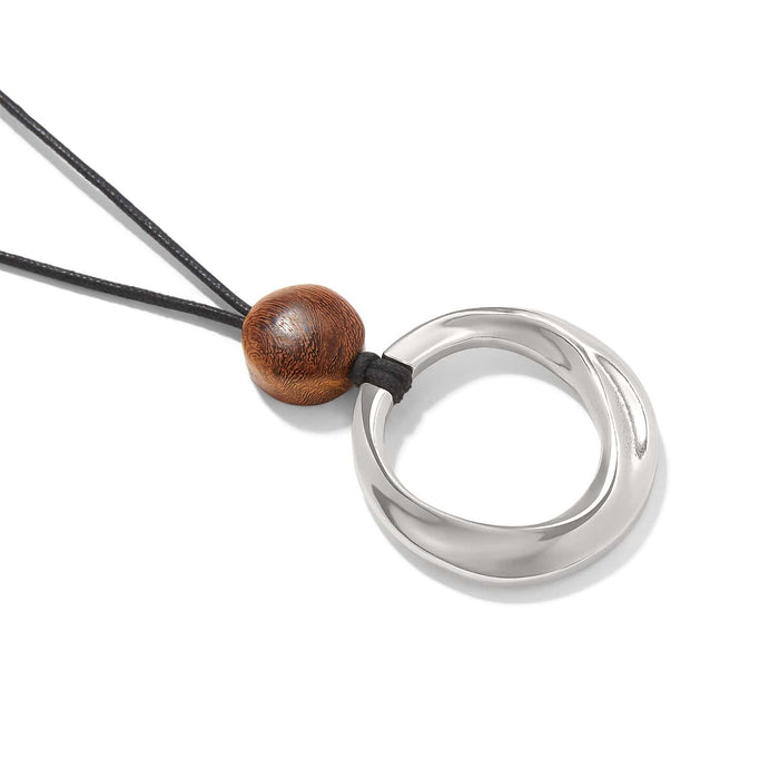 Brighton pendant necklace with silver-plated circular pendant, wood bead accent, and black nylon cord on a white background