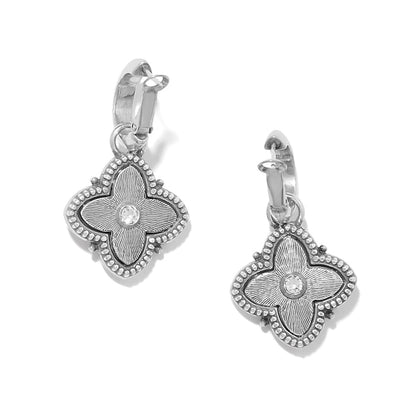 Brighton hoop earrings with silver-tone four-petal flower charms and crystal centers on a white background