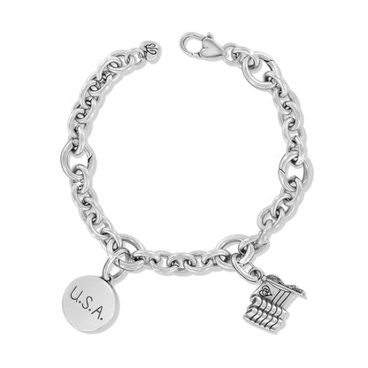 Brighton charm bracelet with silver-plated chain links, U.S.A. engraved disc, and flag charm on a white background