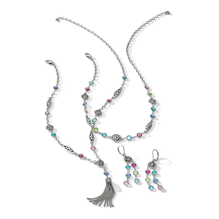 Brighton silver-plated jewelry set with multicolored crystals, scroll-detail links, tassel pendant necklace, and matching earrings on a white background