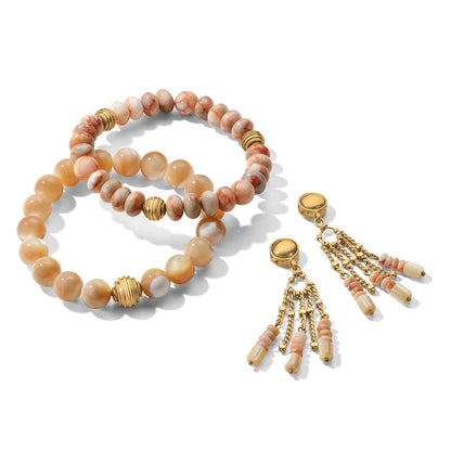 Brighton beaded bracelets with cream and red-veined stones, gold-plated accents, and matching tassel charms on a white background
