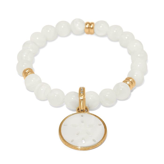 Brighton beaded bracelet with mother-of-pearl beads, gold-plated accents, and sand dollar charm on a white background