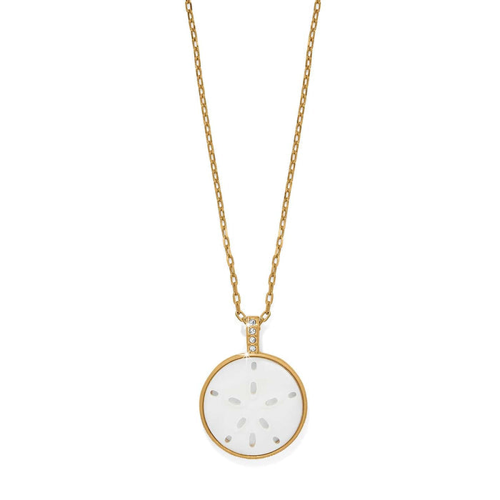 Brighton gold-plated pendant necklace with mother-of-pearl sand dollar disc and crystal-accented bail on a white background