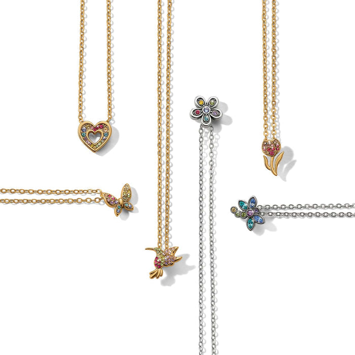 Brighton necklaces styled with silver-plated and gold-tone pendants featuring crystal heart, butterfly, hummingbird, and flower charms