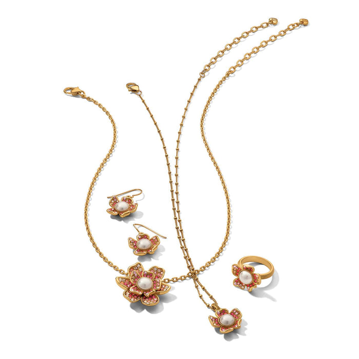 Brighton gold-plated jewelry set with floral pearl and pink crystal necklace, earrings, and ring on a white background