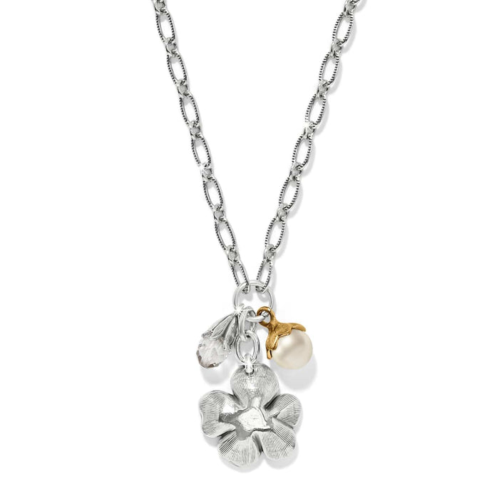 Brighton charm necklace with silver-tone flower, glass pearl, and crystal bead on two-tone chain on a white background