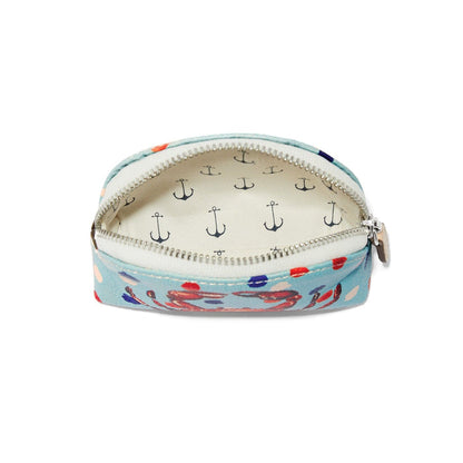 Brighton coin pouch shown open with light blue crab print exterior and anchor print interior on a white background