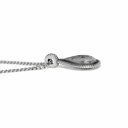 Close-up of Brighton teardrop pendant necklace with hammered silver-plated finish, rope-edge border, and curb chain
