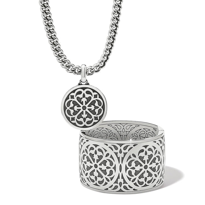 Brighton pendant necklace shown open with silver-plated filigree medallion locket and curb chain on a white background