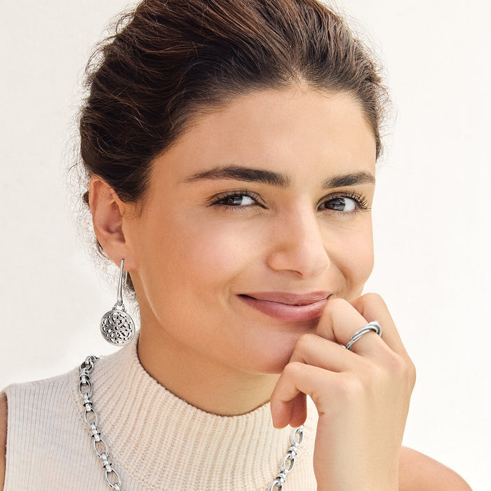 Model wearing Brighton silver-plated drop earrings with round filigree medallions and coordinating Brighton accessories