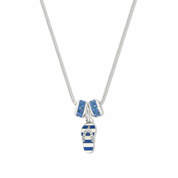 Brighton pendant necklace with blue striped enamel flip-flop charm and two silver-plated crystal rings on a white background