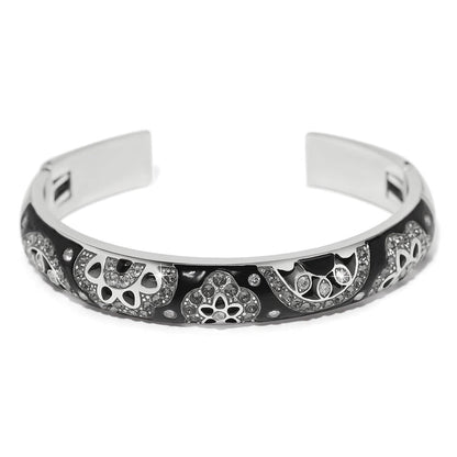 Brighton cuff bracelet with black enamel, silver-plated floral motifs, and crystal accents on a white background