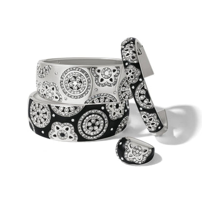Brighton silver-plated bangles and ring with black and white enamel and crystal floral medallions on a white background