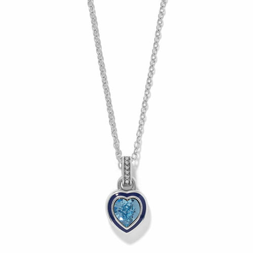Brighton pendant necklace with silver-plated heart, blue enamel border, and blue crystal center on a white background