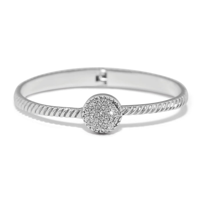 Brighton bangle bracelet with twisted silver-plated band and round crystal pavé centerpiece on a white background
