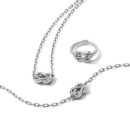 Brighton silver-plated necklace, bracelet, and ring set with crystal-encrusted knot motifs on a white background
