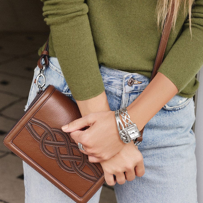 Model in green wearing Interlok Hinged Bangle