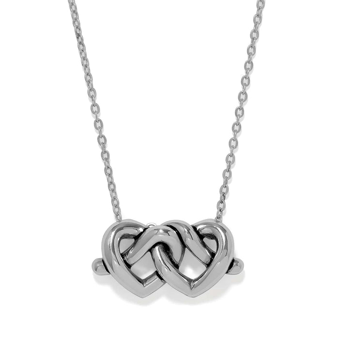 Brighton pendant necklace with two interlocking silver-plated hearts on a delicate chain on a white background