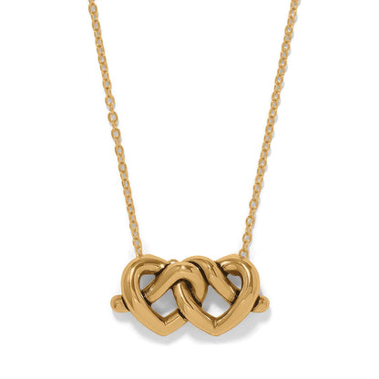 Brighton pendant necklace with two interlocking gold-plated hearts on a delicate chain on a white background