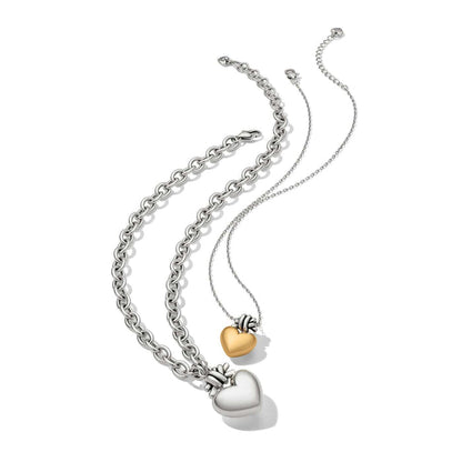 Brighton heart pendant necklaces with silver-plated chunky chain and delicate chain holding gold and silver hearts on a white background