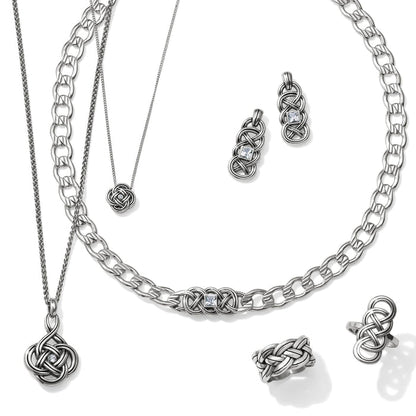 Brighton silver-plated jewelry set styled with interwoven knot pendants, matching earrings, and rings on a white background