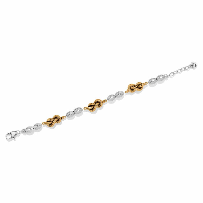 Brighton bracelet with silver-tone oval beads and gold-tone knot accents with adjustable chain on a white background