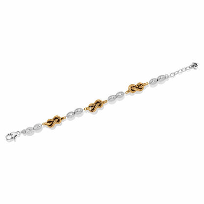Brighton bracelet with silver-tone oval beads and gold-tone knot accents with adjustable chain on a white background