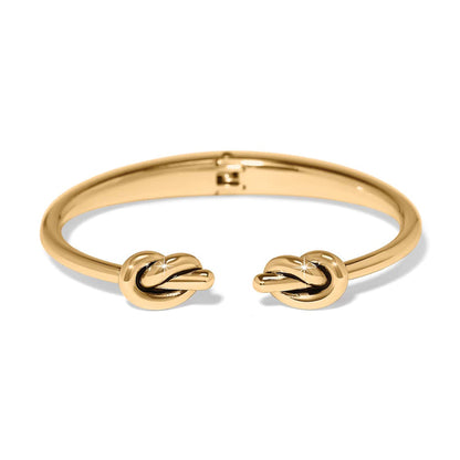 Brighton cuff bracelet with gold-plated finish and double knot end caps on a white background