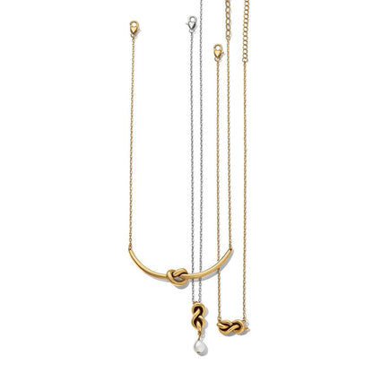 Brighton three necklaces with gold-plated knotted bar, silver chain knot pendant with pearl drop, and gold knot on a white background