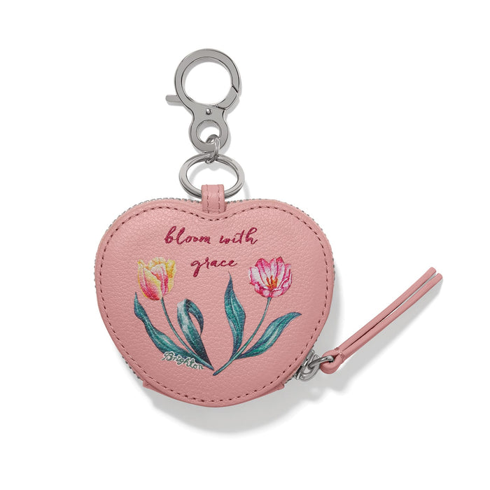 Brighton heart-shaped leather bag charm with floral tulip print, bloom with grace text, and silver-tone clip on a white background