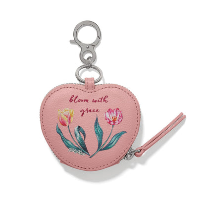 Brighton heart-shaped leather bag charm with floral tulip print, bloom with grace text, and silver-tone clip on a white background