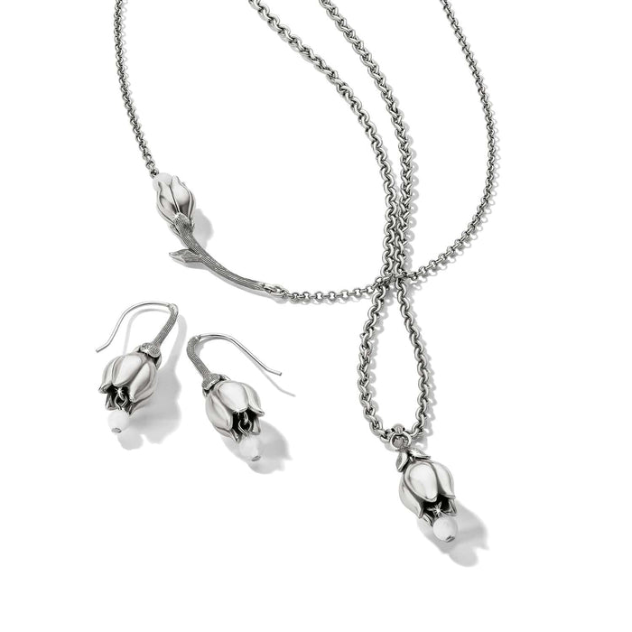 Brighton silver-plated necklace and drop earrings set with tulip-shaped pendants and white bead accents on a white background