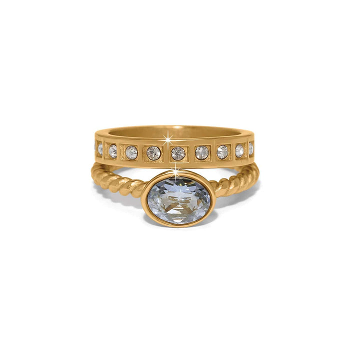 Brighton gold-plated stacked rings with oval crystal center stone and crystal-accented band on a white background