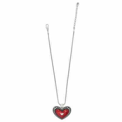 Brighton pendant necklace with red enamel heart, silver-plated beaded border, and snake chain on a white background