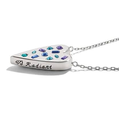 Close-up of Brighton heart pendant necklace with multicolored crystals and engraved B Radiant inscription on silver-plated finish