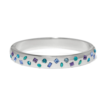 Brighton silver-plated bangle bracelet with scattered blue, purple, and teal crystals in mixed shapes on a white background